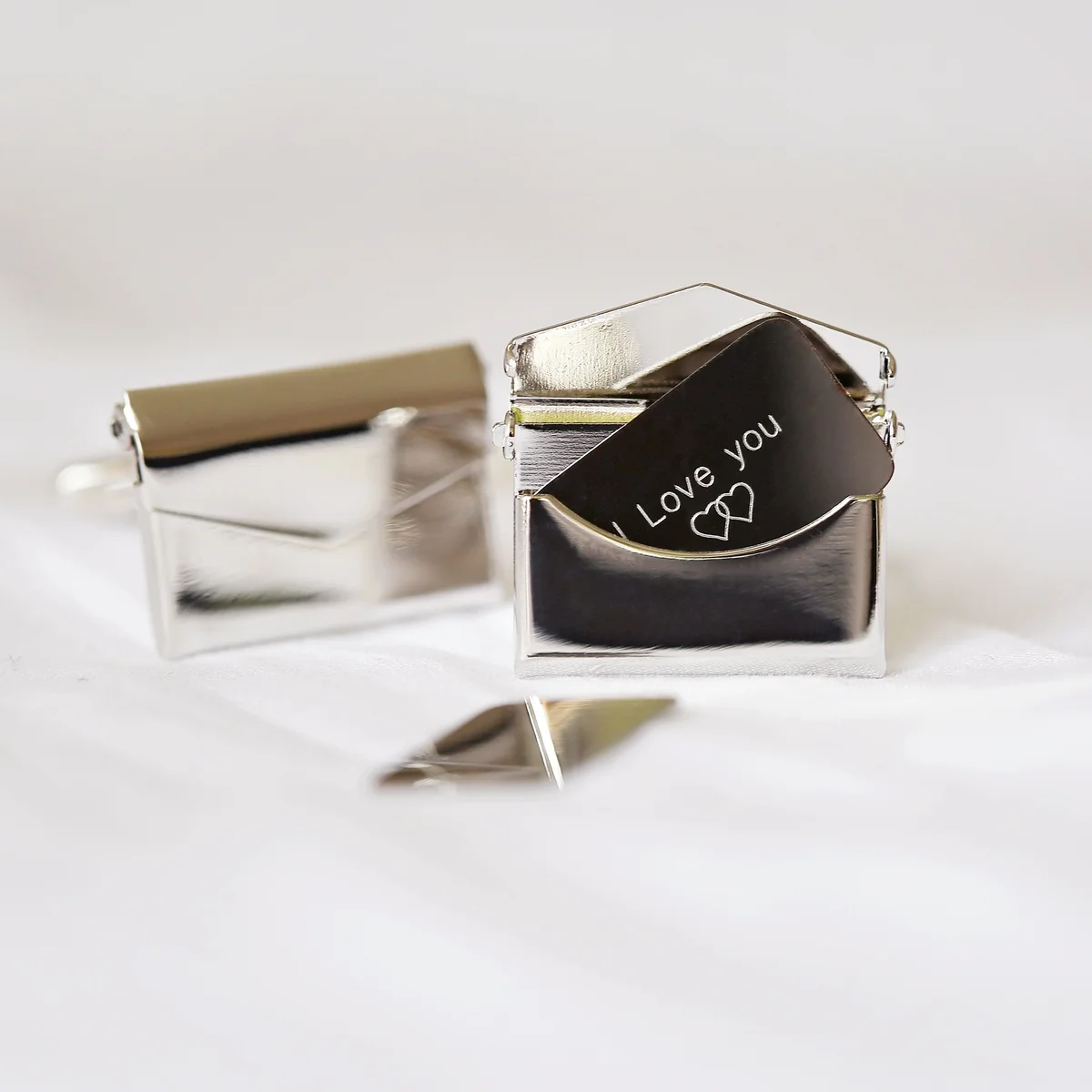 Pair of polished stainless steel personalised cufflinks with engraved secret message and eco-friendly gift box