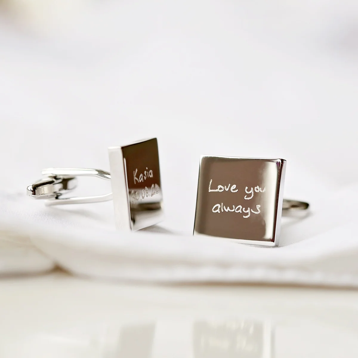 Pair of 17mm stainless steel cufflinks engraved with custom handwriting, shown in polished silver finish with eco box