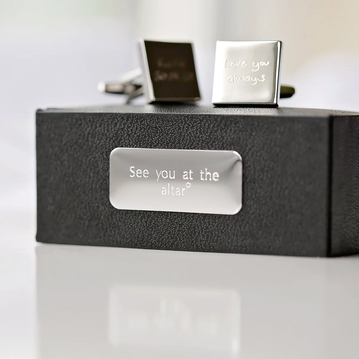 Silver personalised handwriting cufflinks engraved with a child's drawing, displayed on a white background with eco-friendly box