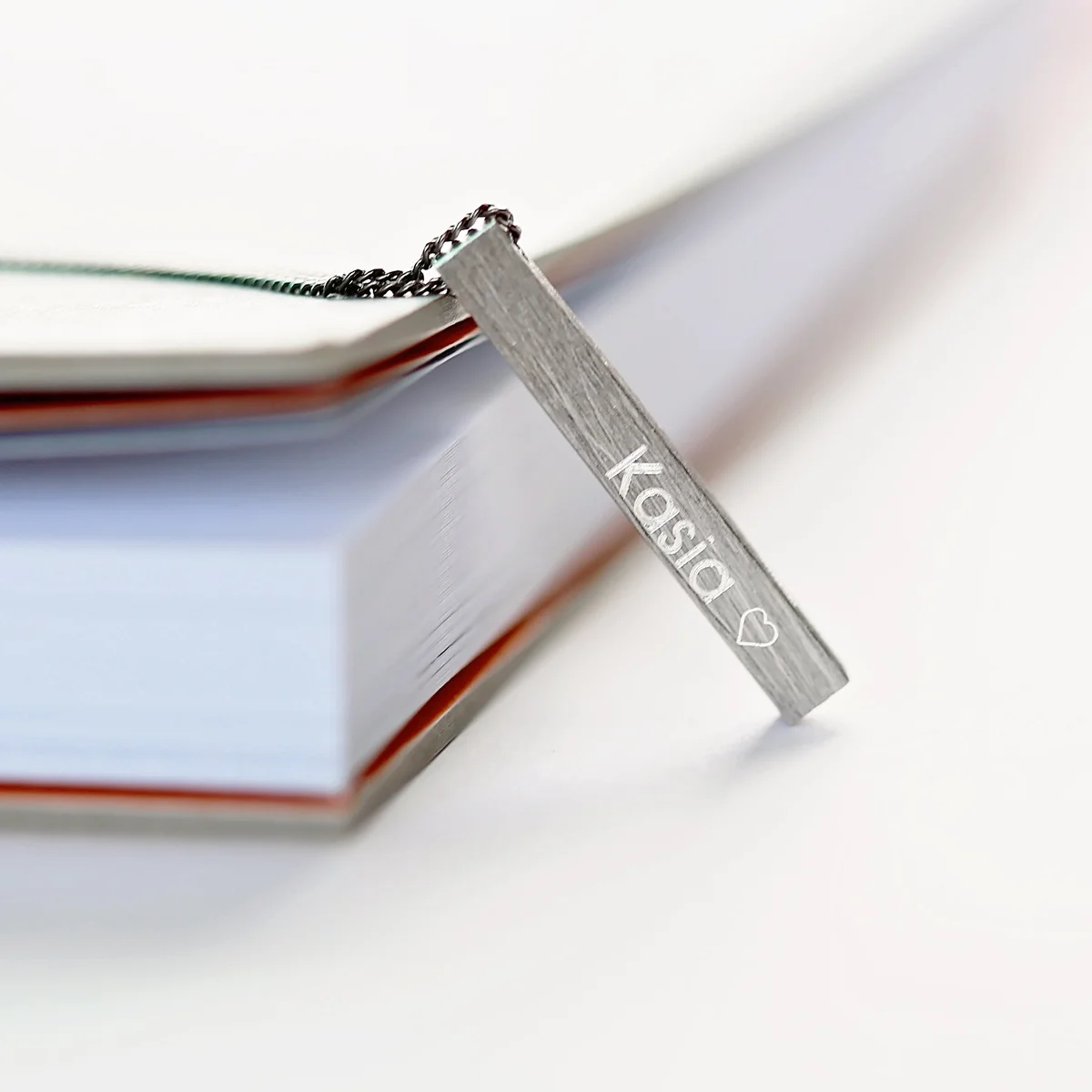 Brushed finish personalised men's necklace 30mm long with engraved text, displayed in Wear We Met gift box with blue shred