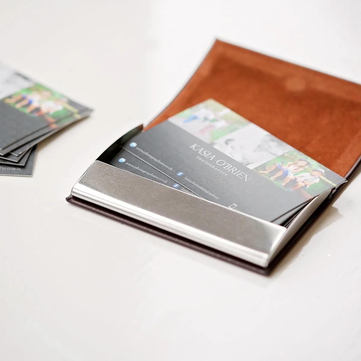 Brown engraved vegan-friendly stainless steel credit card holder with snap-lock magnetic closing and gift pouch
