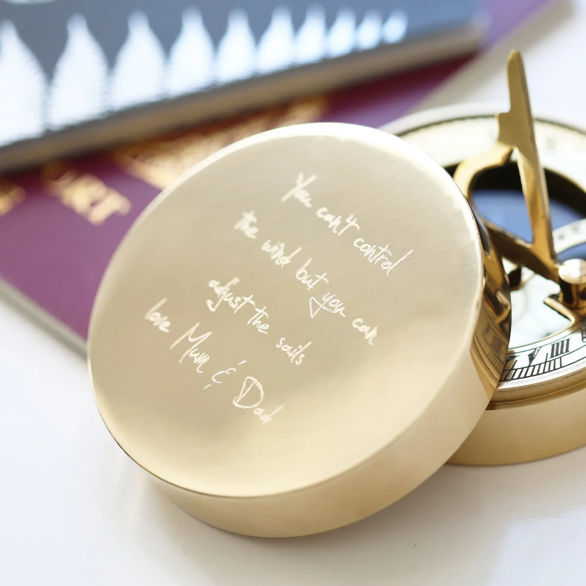 Personalised sundial compass with brass finish, engraved with handwriting, shown with protective pouch and gift box