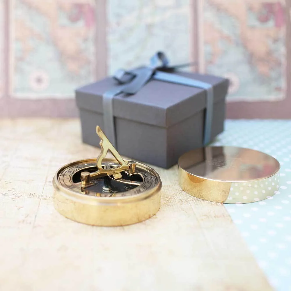 Brass nautical sundial compass with personalised handwriting engraved gift, shown with protective pouch and gift box packaging