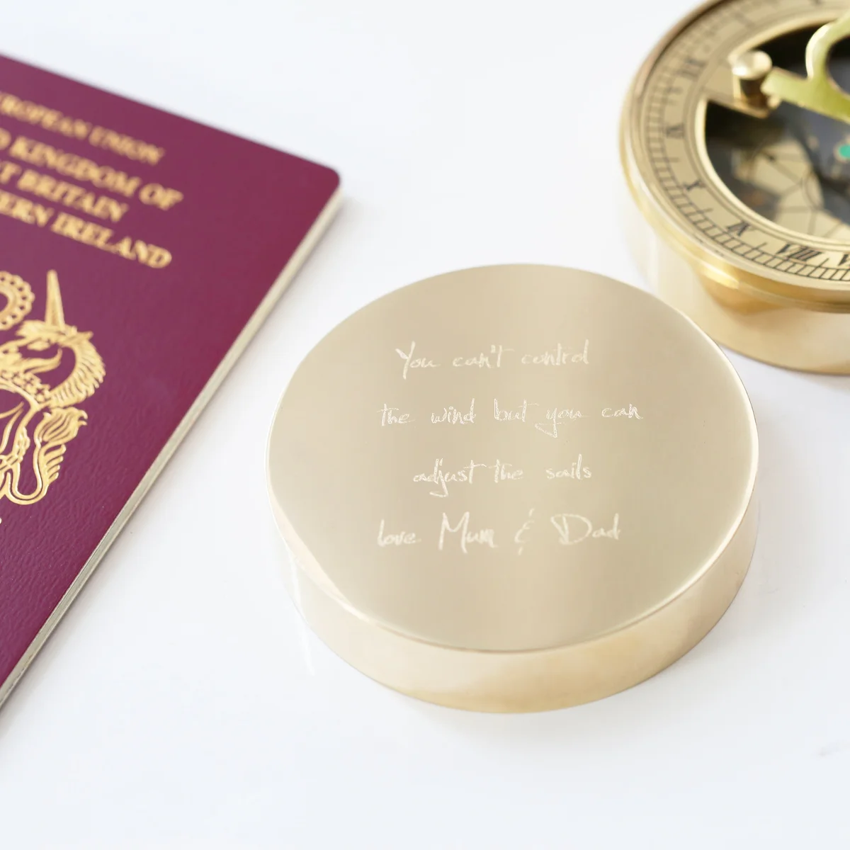 Personalised sundial compass with own handwriting engraving, brass finish, shown with protective pouch and gift box packaging