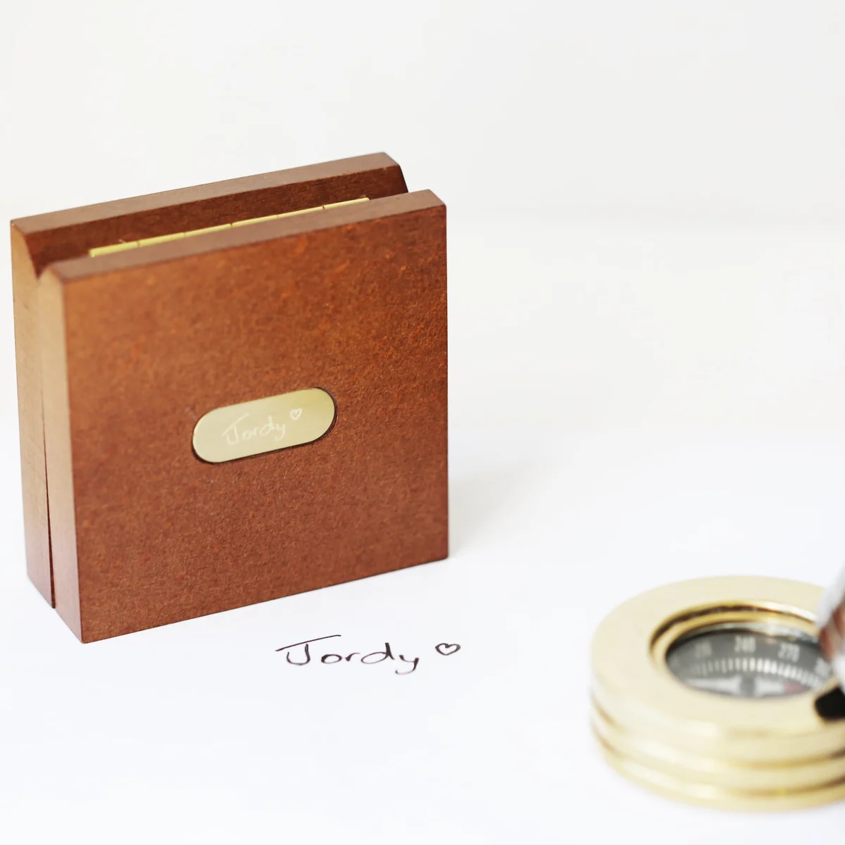 Engraved compass with box showing brass compass in mahogany timber box with monogrammed brass plate and ribbon gift wrap