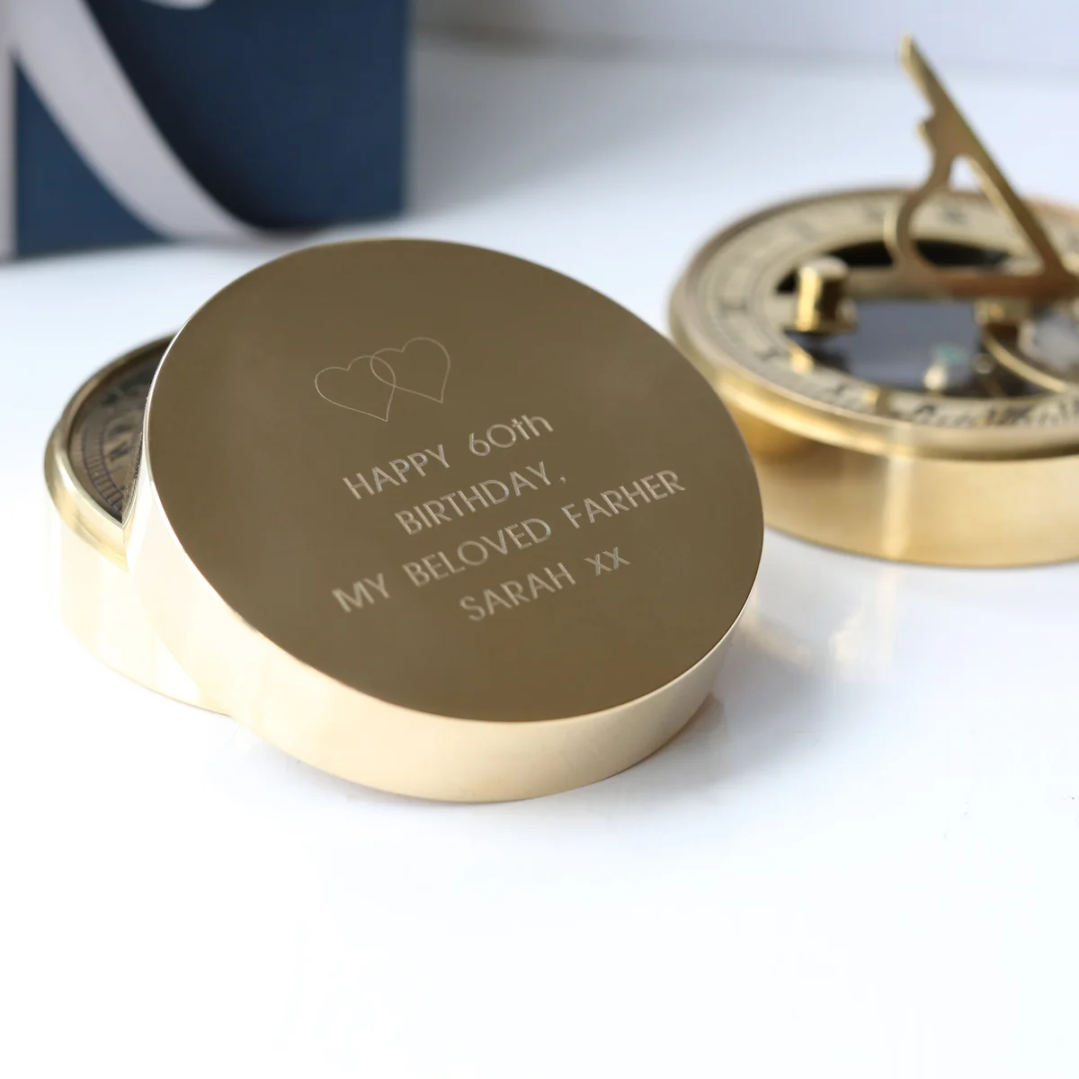 Engraved brass nautical sundial compass with personalised message, protective pouch, gift box, and ribbon packaging