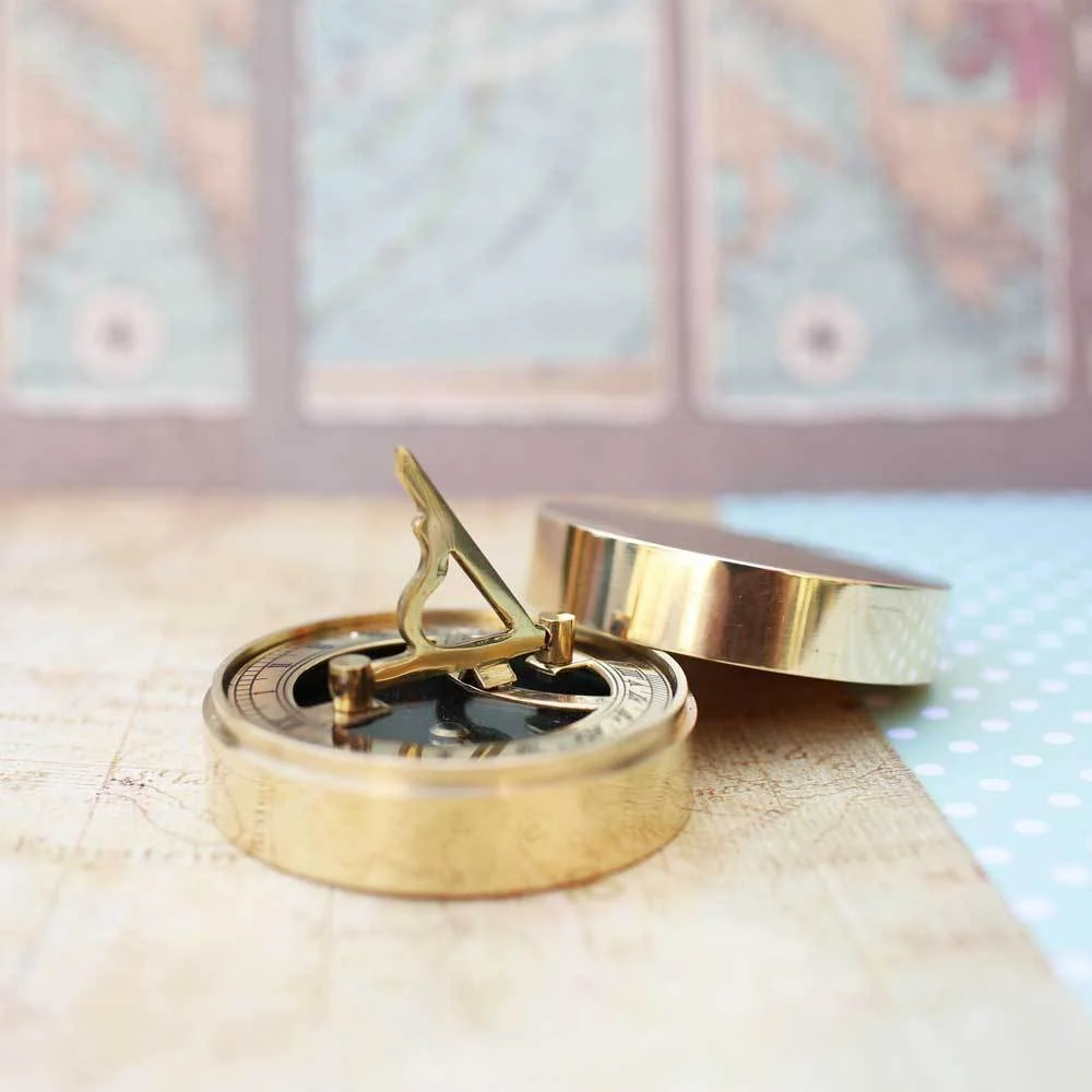 Engraved brass personalised compass gift with sundial, protective pouch, and gift box with ribbon and shredded paper