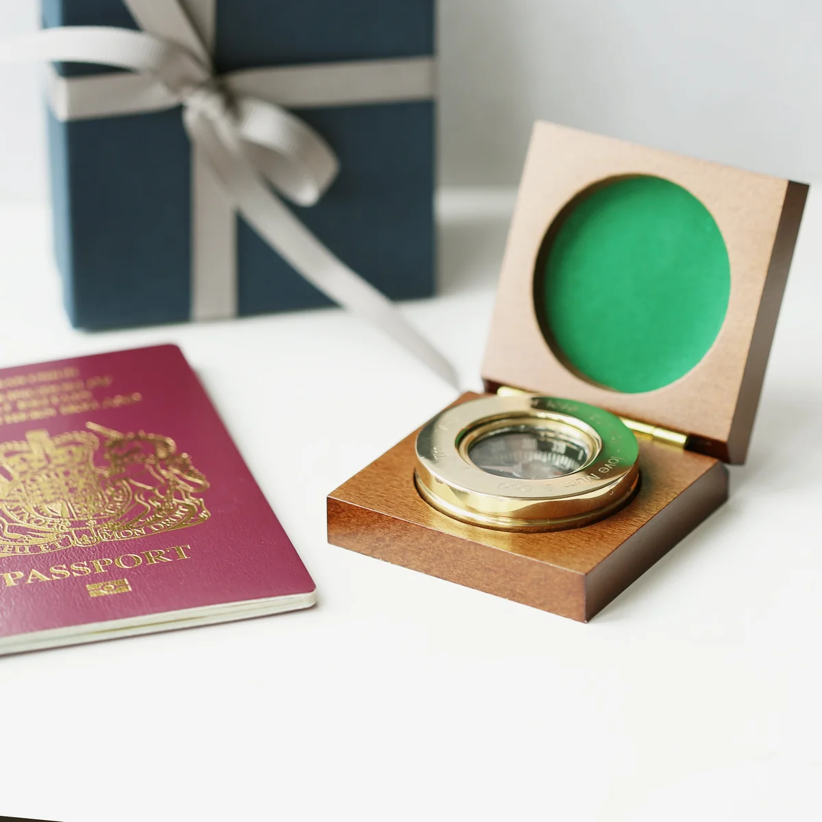 Brass compass engraved with modern font inside open mahogany box with monogrammed brass plate, mahogany compass gift