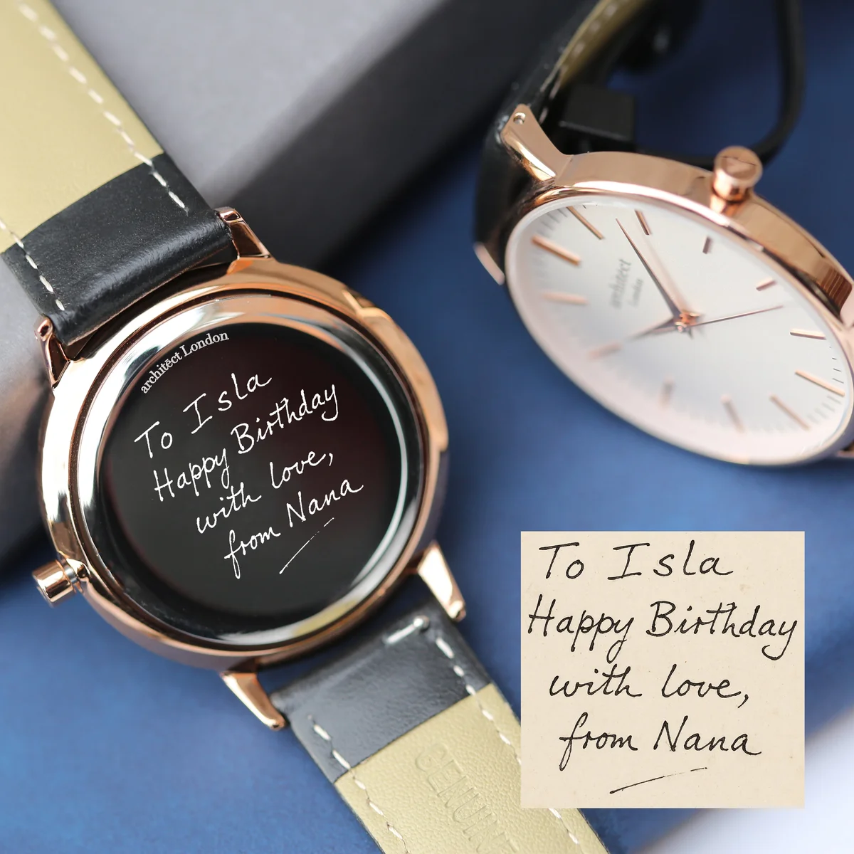 Personalised ladies watch with white dial, rose-gold details, black leather strap, and stainless steel case on white background