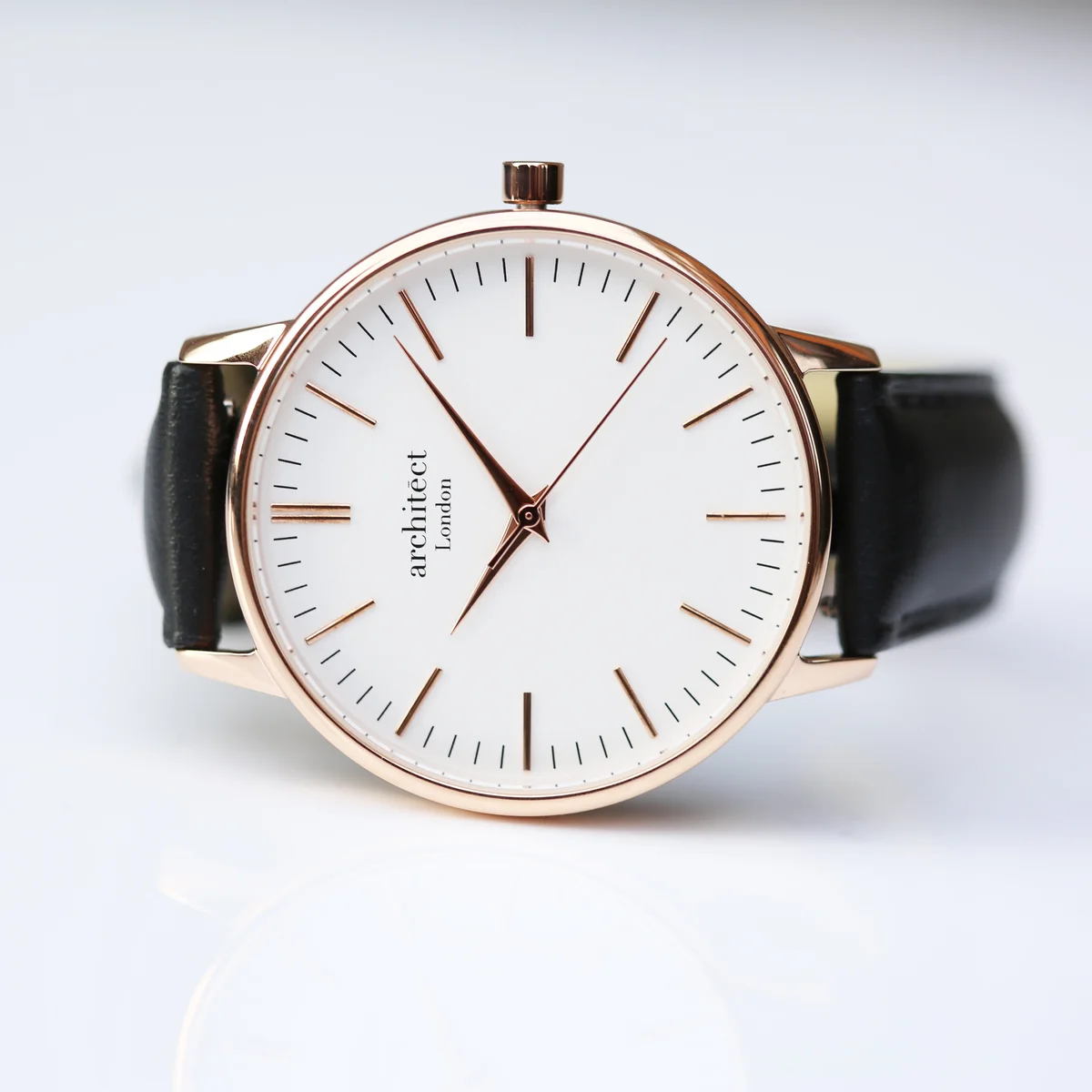 Personalised ladies watch with rose gold case and black leather strap displayed on white background