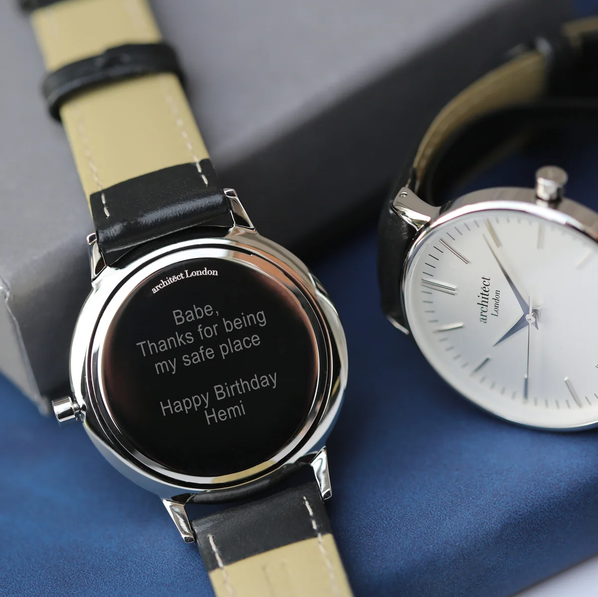 Ladies silver bezel watch with modern font engraving and black leather strap watch on white background