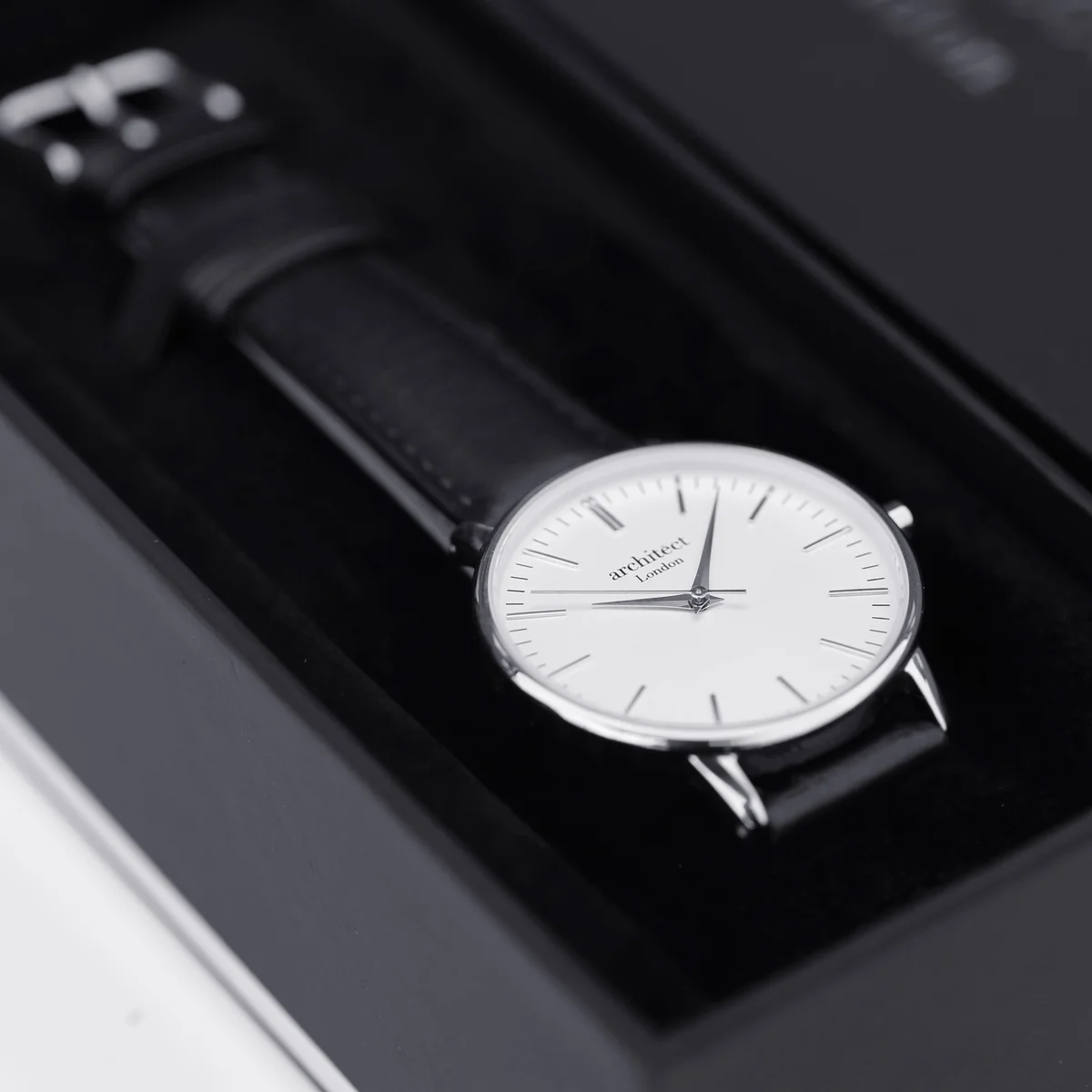 Engraved ladies watch with silver bezel, black genuine leather strap, modern font engraving on stainless steel case back