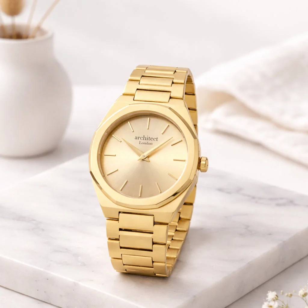 Ladies gold tone bracelet watch with minimalist white dial and modern font engraving on stainless steel case