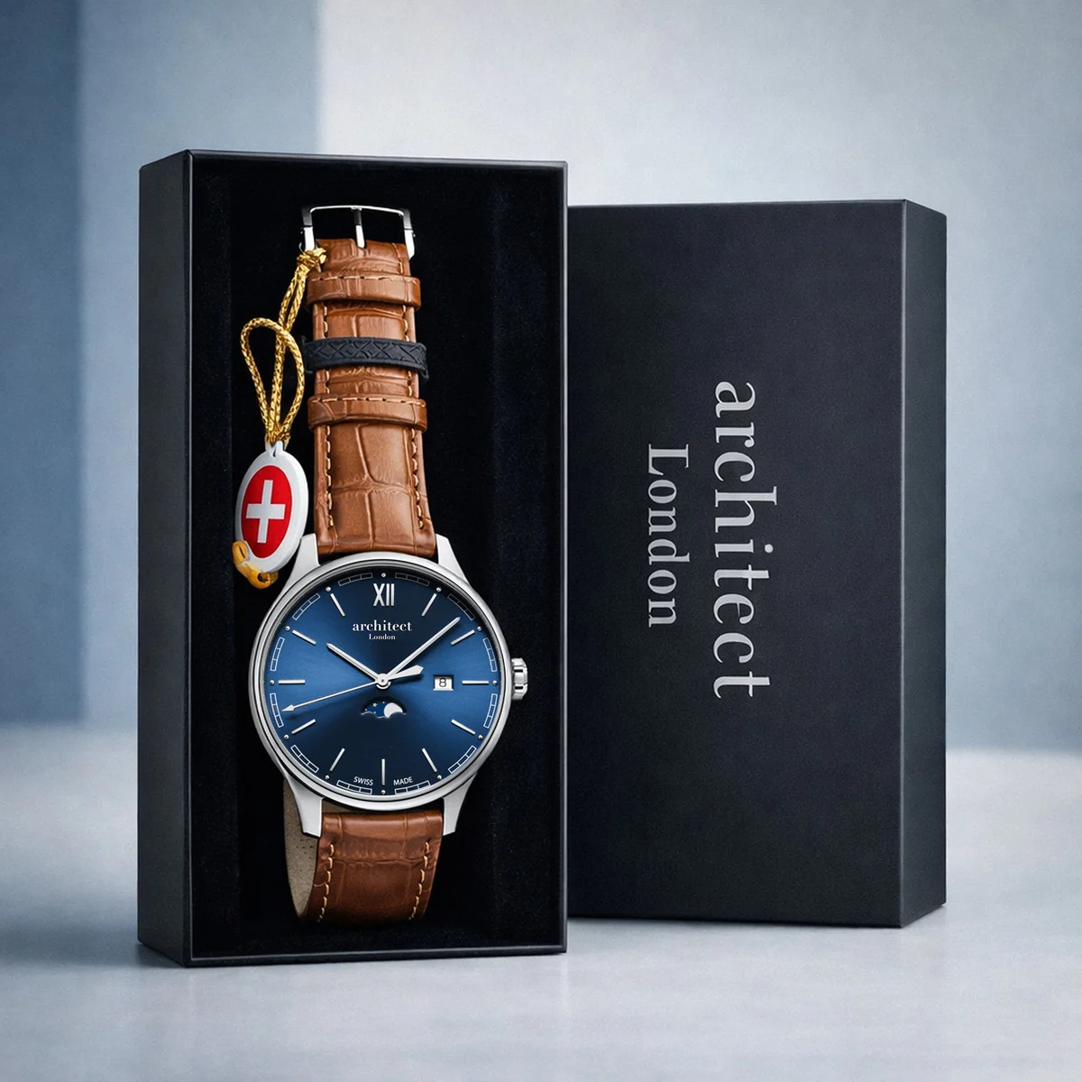 Silver stainless steel watch with blue dial moonphase watch and brown leather strap on white background