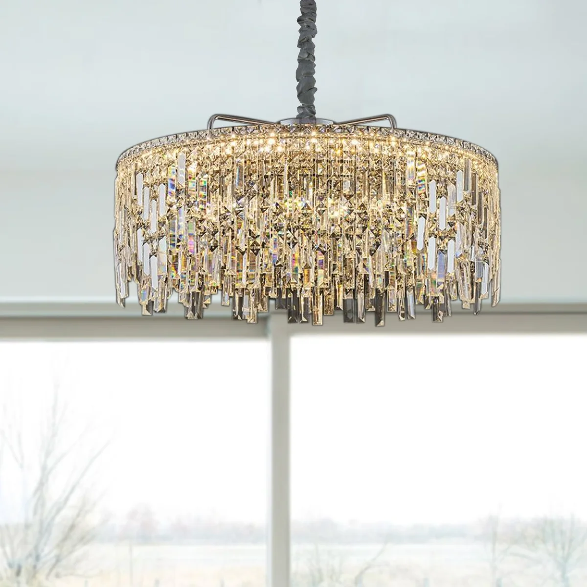 Modern gold indoor crystal chandelier with round frame and clear crystal drops hanging from ceiling mount