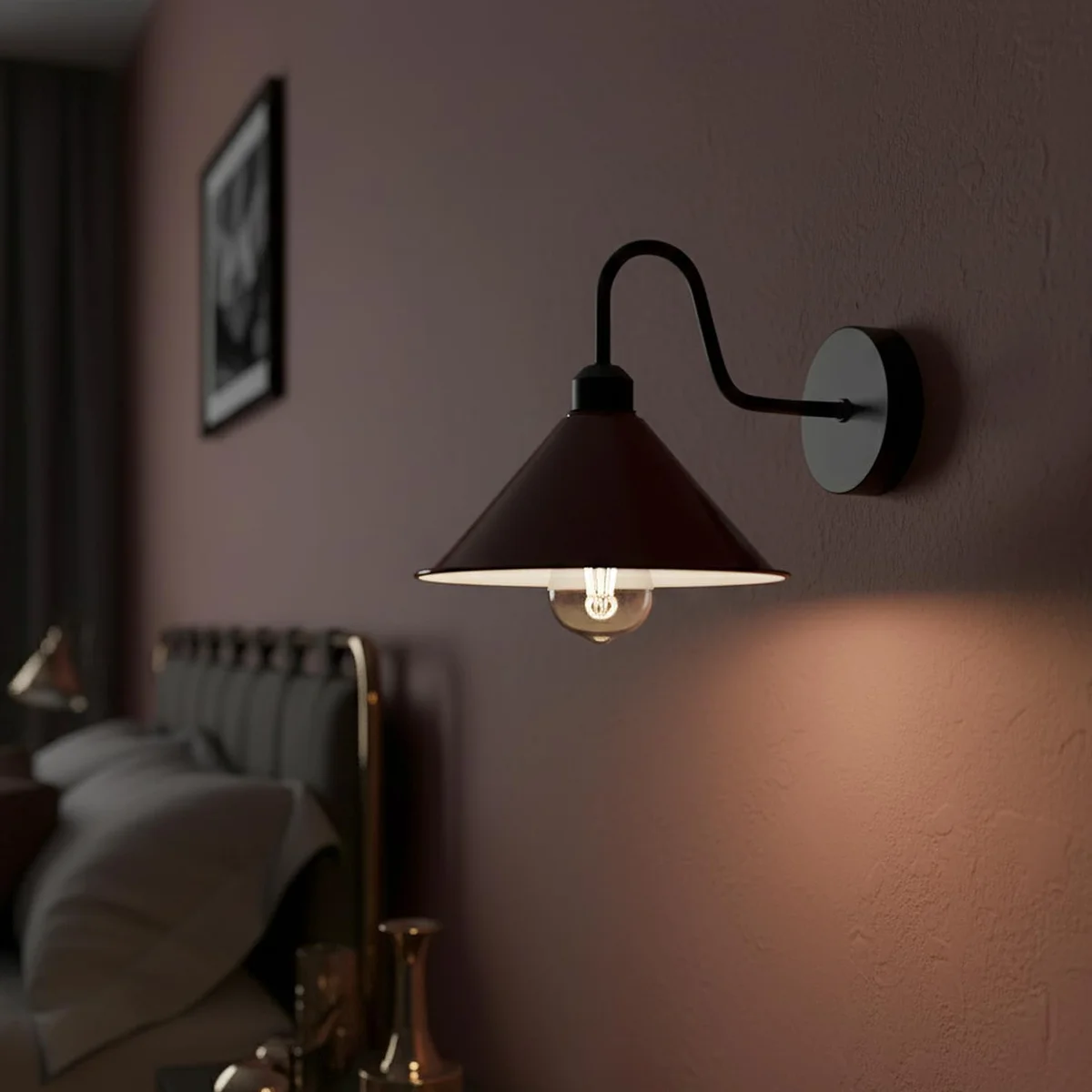 Burgundy gooseneck wall lamp with curved arm and cone shade mounted on a white wall in a living room setting