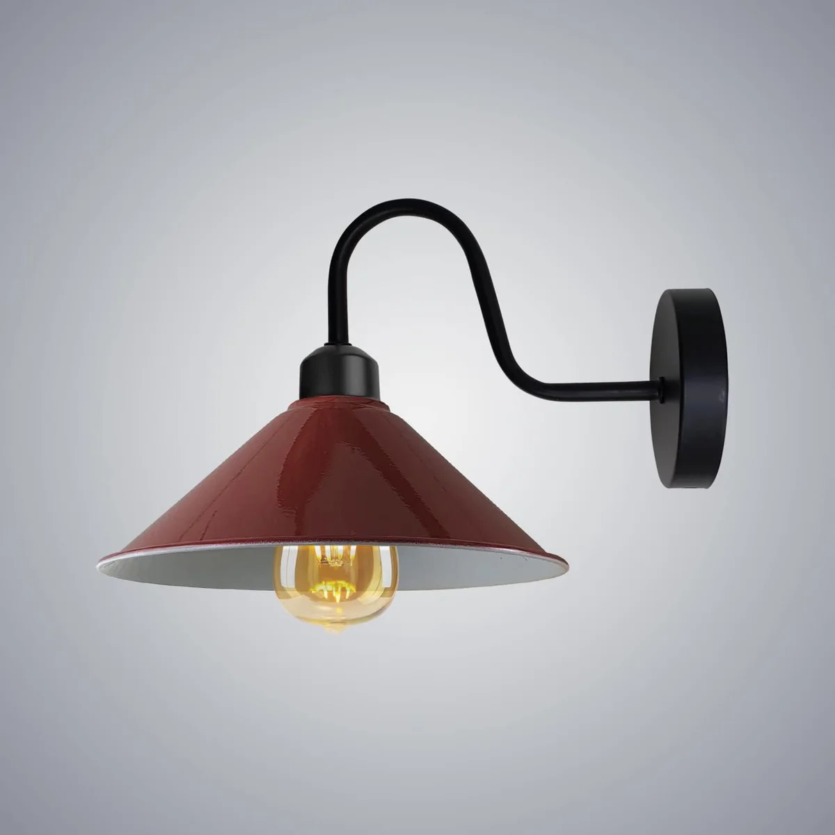Vintage burgundy metal cone shade lamp with curved gooseneck arm mounted on a wall, ideal for bedside reading light