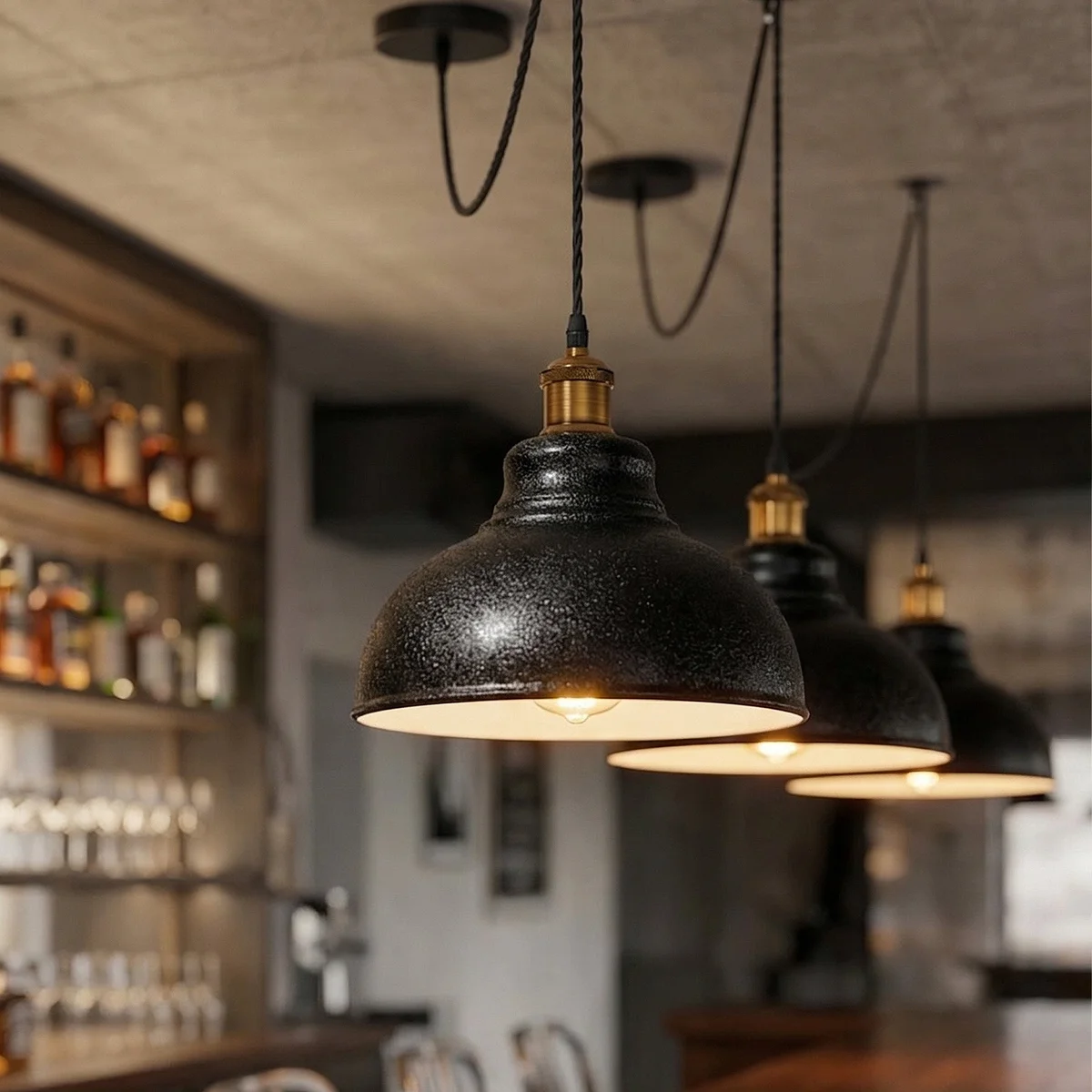 Black industrial pendant light with curvy metal shade, white interior, and adjustable 2m twisted fabric cable hanging from ceiling