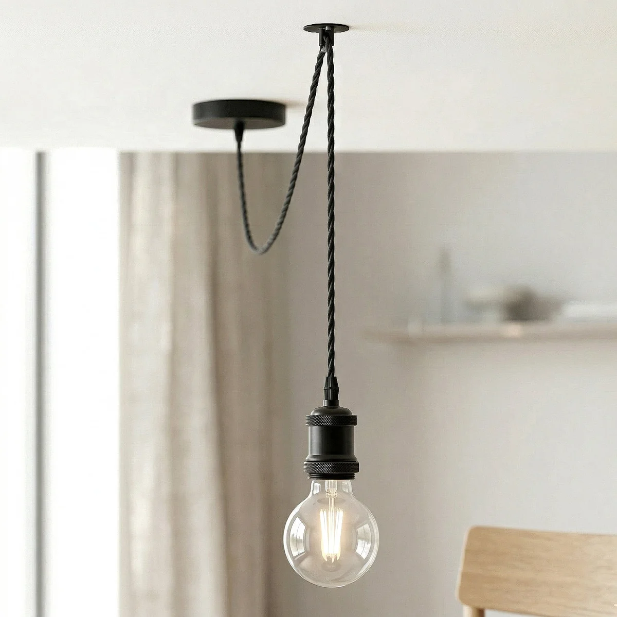 Black industrial pendant light with adjustable 2m twisted fabric cable and included amber G80 LED bulb