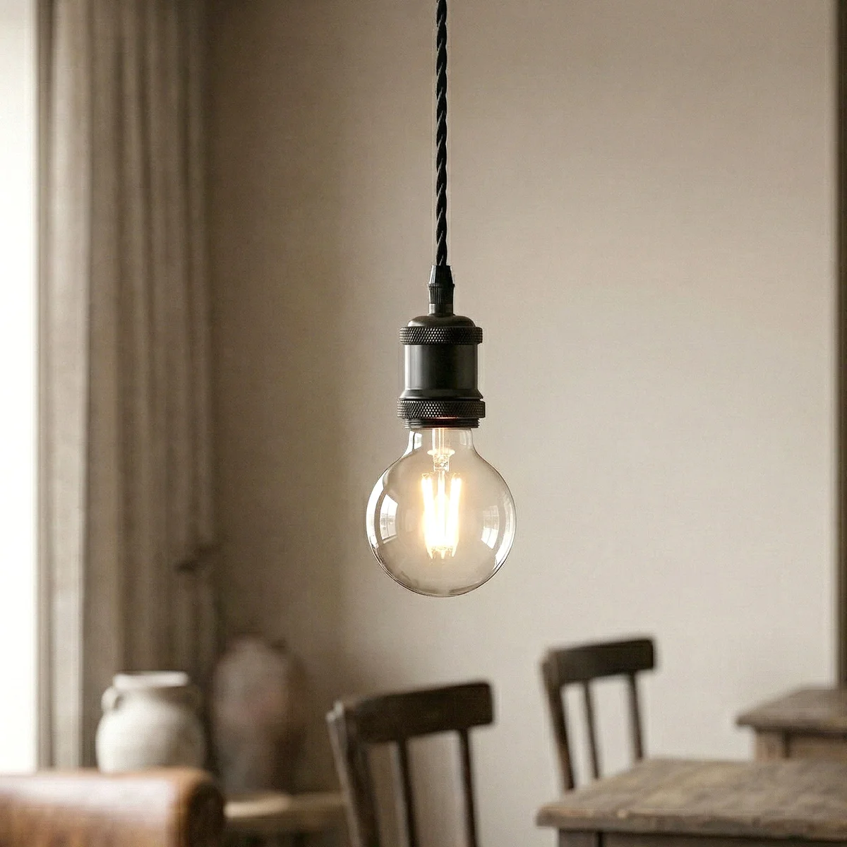 Black industrial pendant light with adjustable 2m cable and warm glowing E27 bulb pendant hanging from ceiling